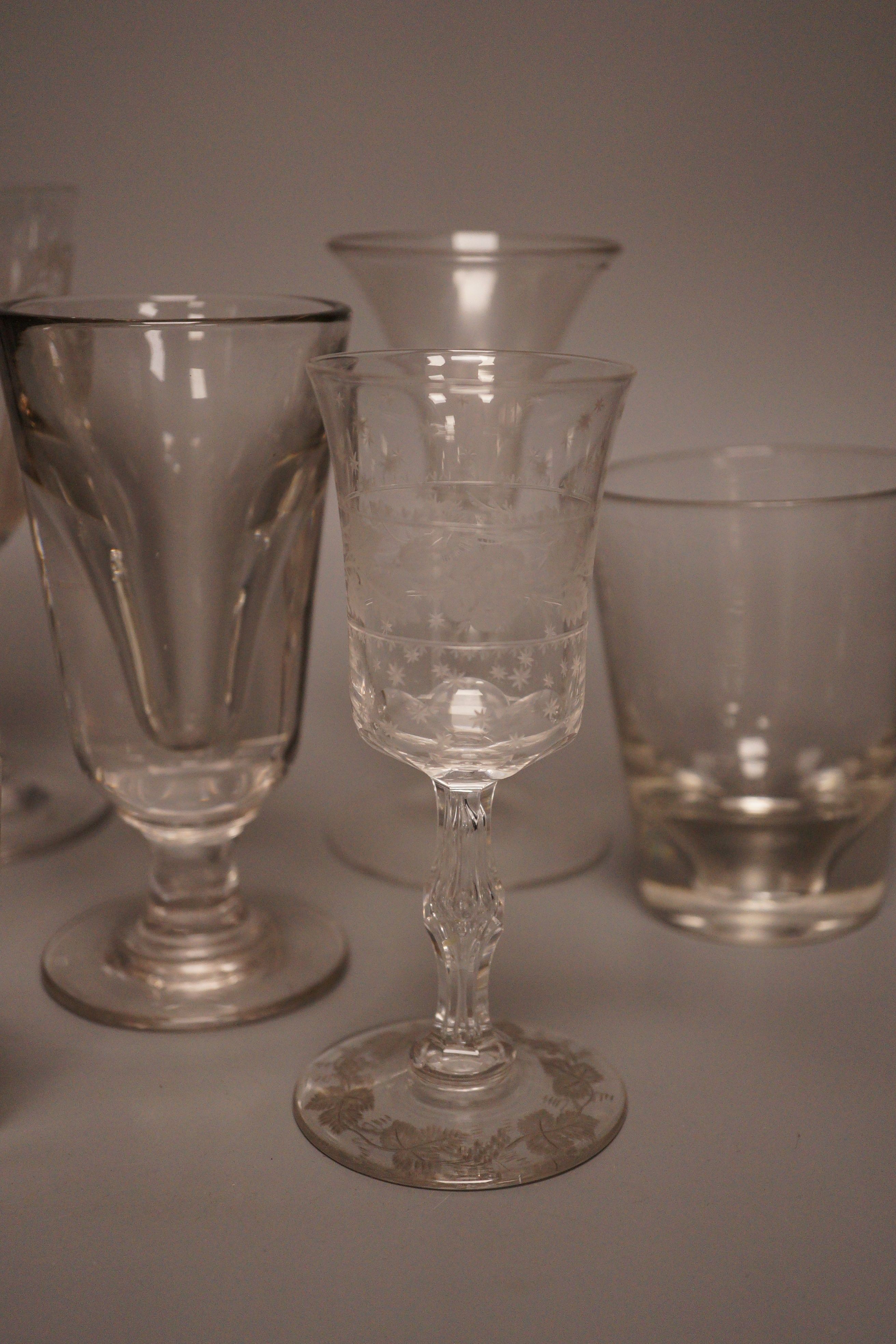 A group of eight 19th/20th century novelty or commemorative glasses, tallest 19.5 cm, including two deceptive glasses, a wheel engraved tumbler with hangman to the base etc.
